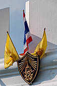 Bangkok. Coat of arms on the crenellated walls of the Grand Palace.